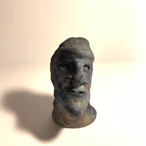 Raku clay sculpture, staring face. AGE